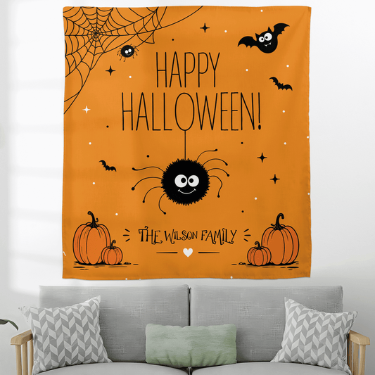 Orange cute spider Happy Halloween family name tapestry above a grey sofa