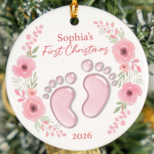 Round ceramic ornament with a pink floral wreath, baby feet, a baby name's First Christmas and the year