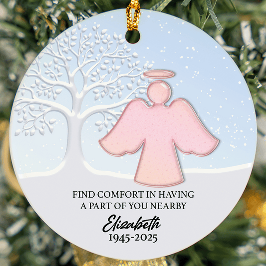 Round memorial ornament with a pink angel, the comfort quote, a name and years