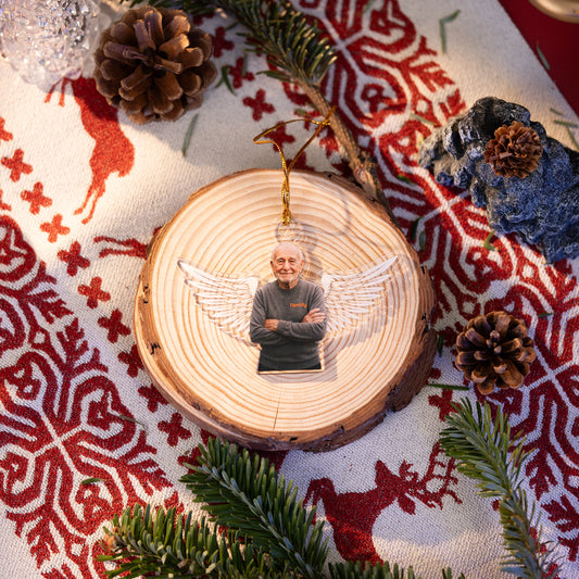 Angel wings photo memorial ornament on a wood slice on a Nordic cloth