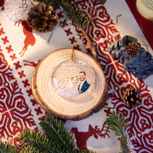 First Christmas Married photo glass ornament on a wood slice on a Nordic cloth
