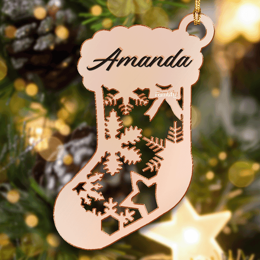 Rose gold mirrored stocking ornament with a cut-out snowflake pattern and a custom name