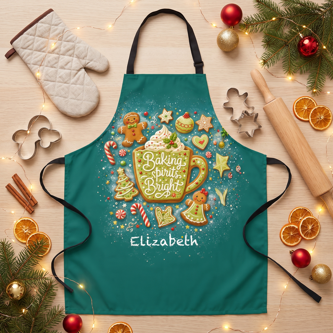 Teal Baking Spirits Bright apron with gingerbread, cookies, cocoa mug and custom name, flat lay