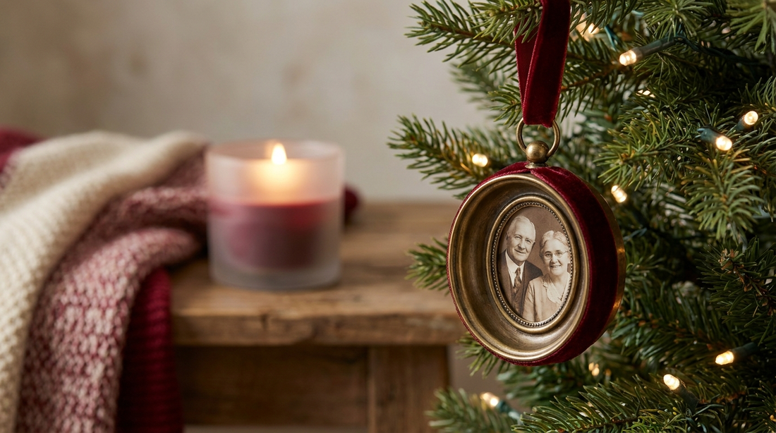 Memorial Christmas ornament with a photo hanging on a tree beside a soft candle glow