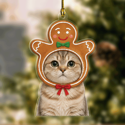 Acrylic ornament with a custom cat photo framed by a gingerbread man hood with green bow and red collar bow
