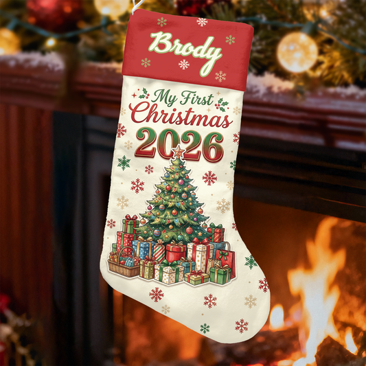My First Christmas 2026 custom name stocking with tree and presents hanging by a fireplace