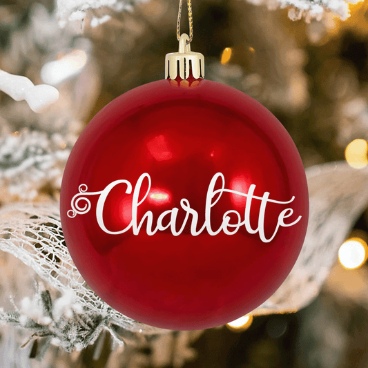 Glossy red shatterproof ball ornament with large white script custom name and swirl