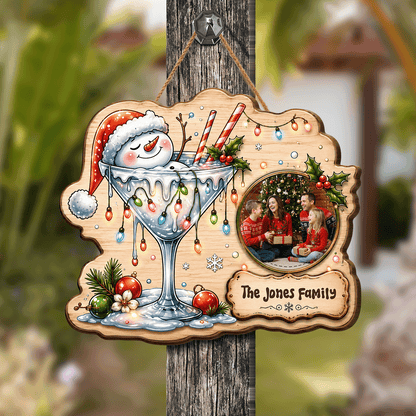 Shop custom Christmas wooden signs! Durable 0.5cm plywood cutout featuring a snowman in a cocktail glass, Christmas lights, custom family photo & personalized plaque!