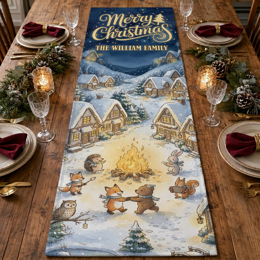 Quilted table runner with Merry Christmas and custom family name above a snowy village where foxes, bears and owl gather at a campfire