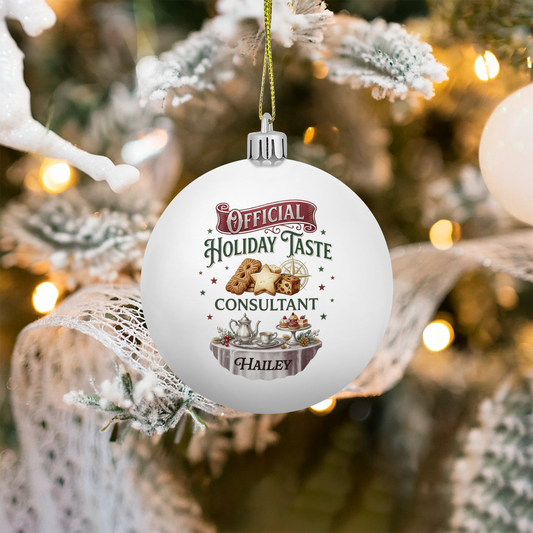 White ball ornament printed Official Holiday Taste Consultant with cookies, teapot and custom name