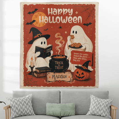Personalized vintage Halloween ghost tapestry hanging above a grey sofa with patterned pillows