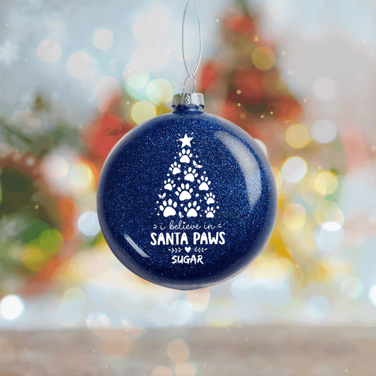 Navy glitter ornament with a paw print Christmas tree and I believe in Santa Paws with custom dog name