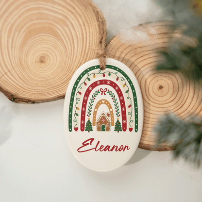 Christmas rainbow name ornament hanging against wood slices