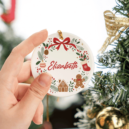 Hand holding the round bow wreath personalized ceramic ornament