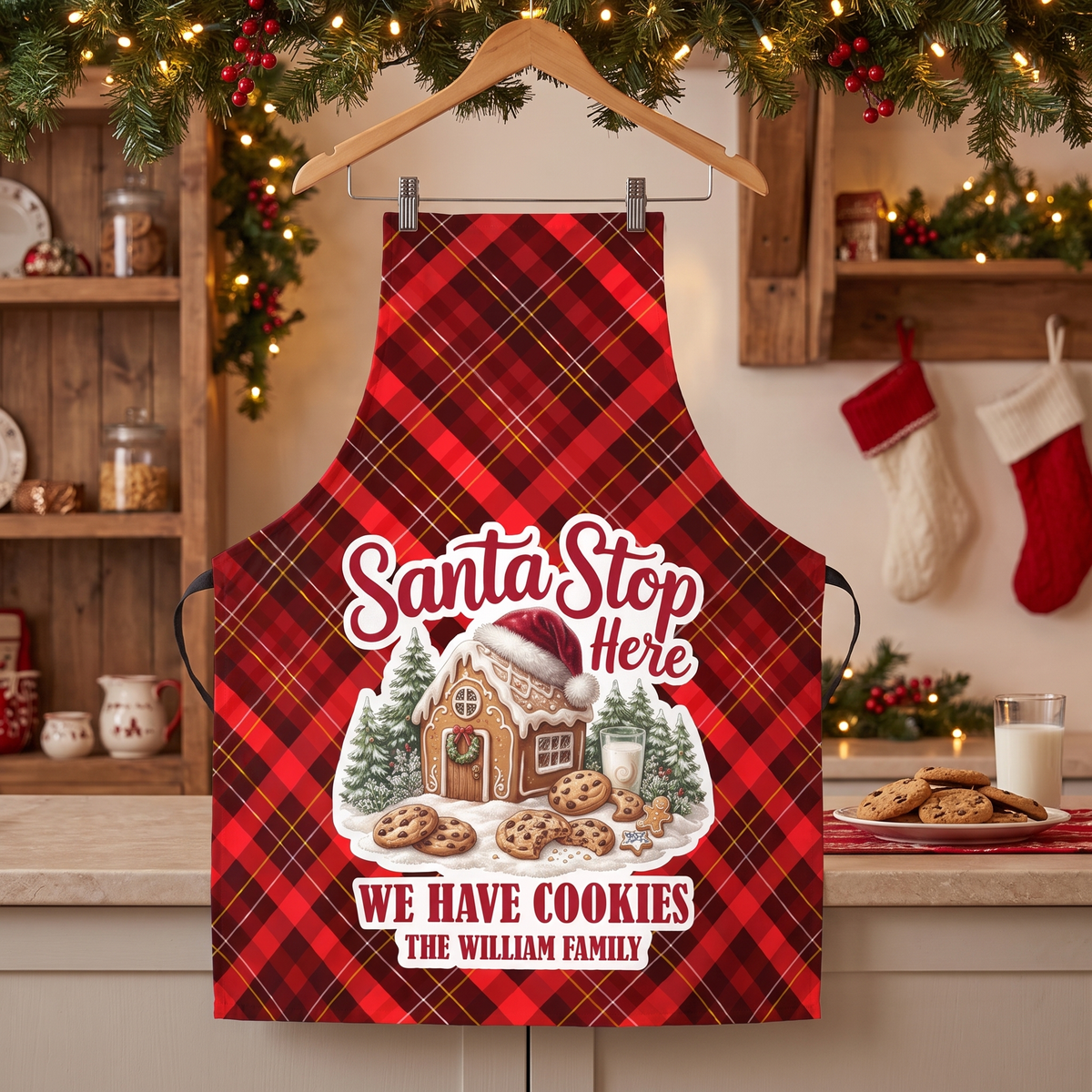 Red plaid Santa Stop Here We Have Cookies custom family name apron on a hanger by stockings