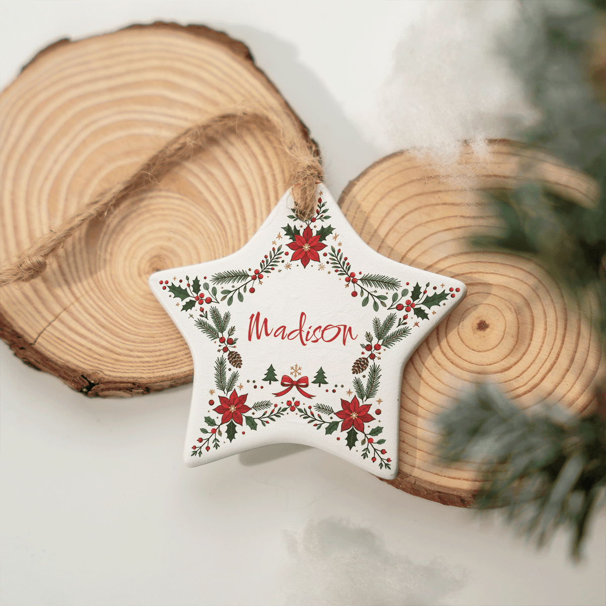 Ceramic star name ornament resting against wood slices