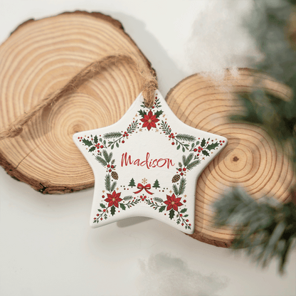 Ceramic star name ornament resting against wood slices