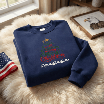 Navy We Wish You a Merry Christmas sweatshirt on a fur rug with a flag and eagle print