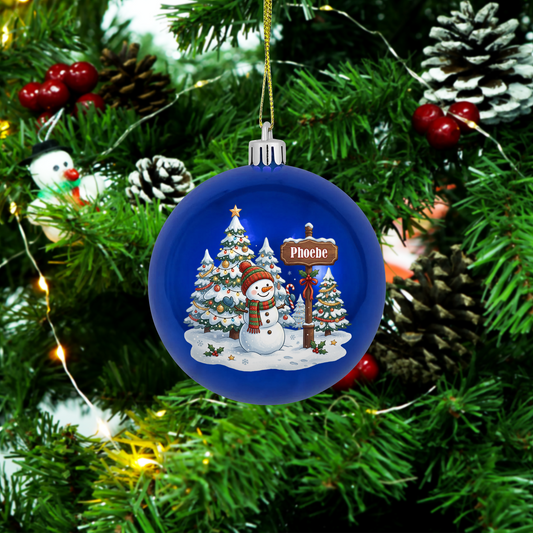Blue ball ornament with a snowman in a winter forest scene and custom name signpost