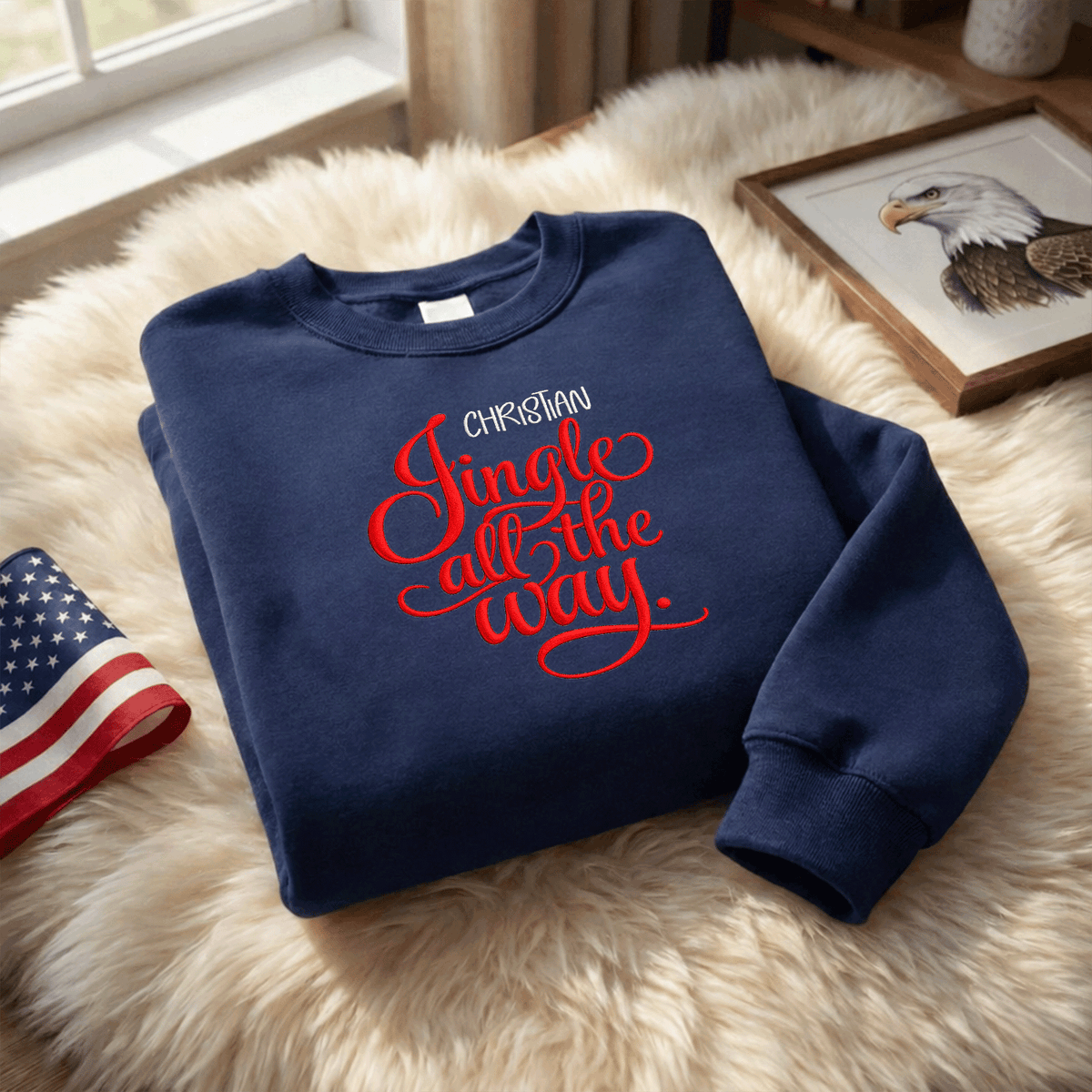 Navy Jingle All the Way script sweatshirt on a fur rug with a flag and eagle print