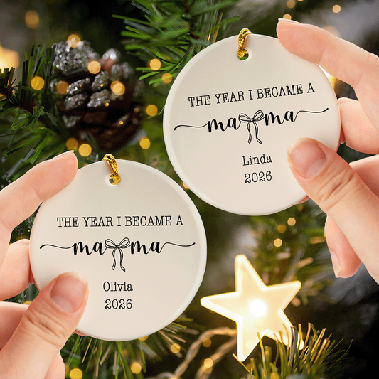 Hands holding two round ceramic ornaments printed The Year I Became a Mama with different custom names near a lit star