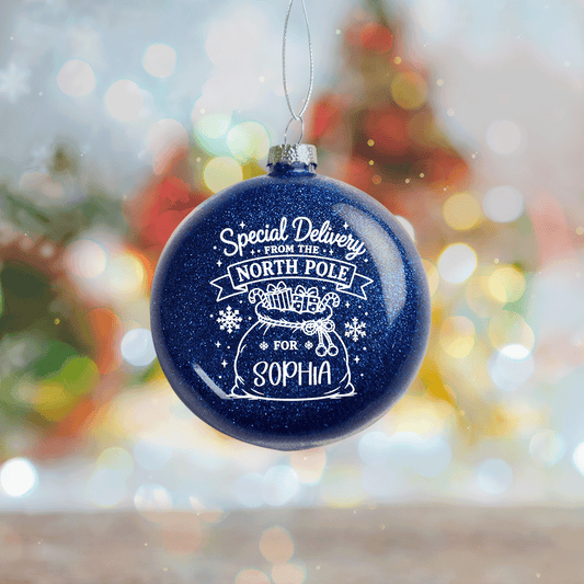 Navy glitter ball ornament printed Special Delivery From The North Pole with Santa sack and custom name