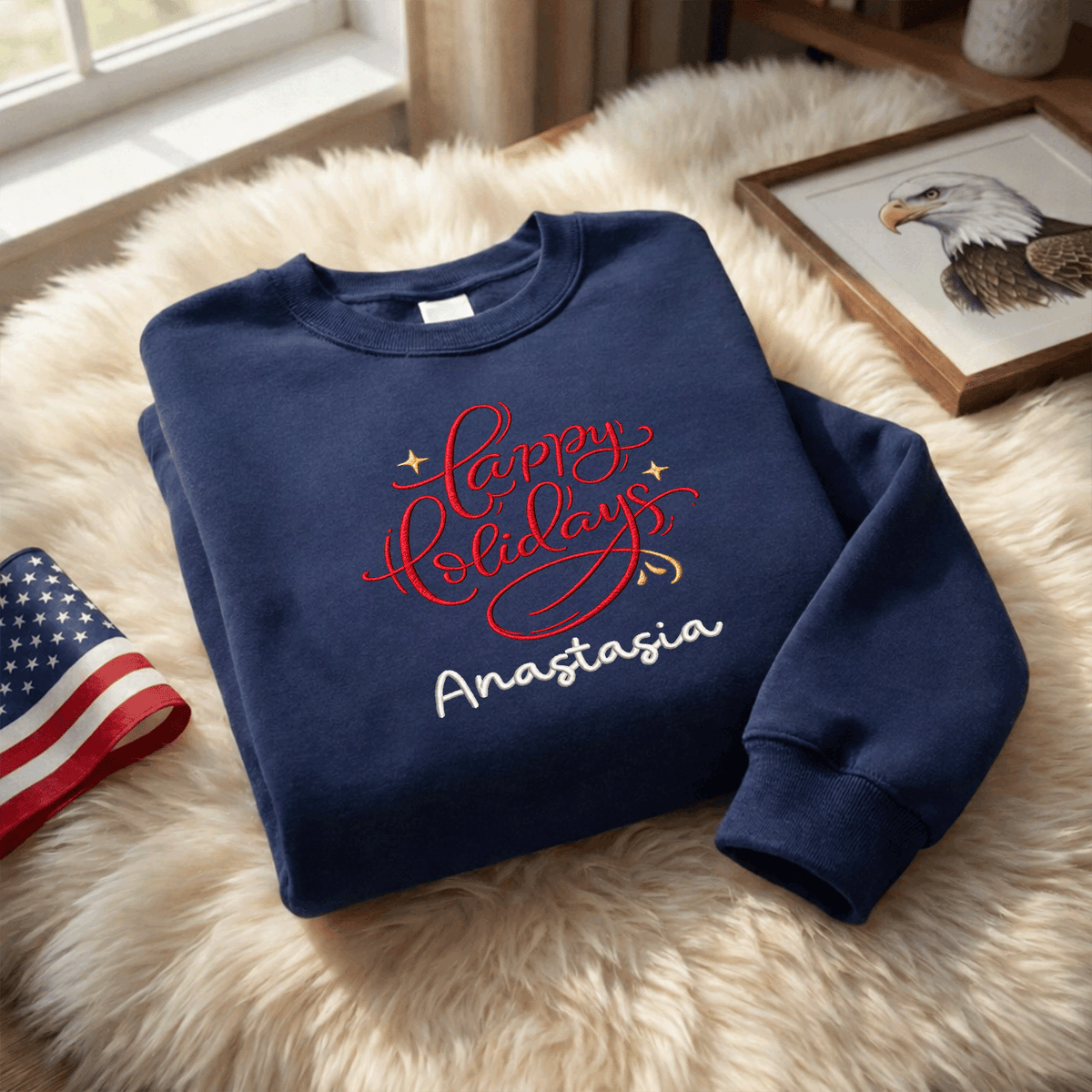 Navy red Happy Holidays sweatshirt on a fur rug with a flag and eagle print