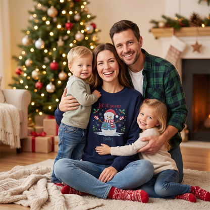 Family by the tree with mom in the navy personalized Let It Snow snowman sweatshirt