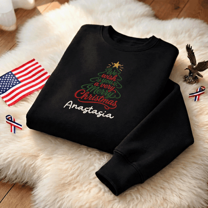 Black We Wish You a Merry Christmas sweatshirt on a fur rug with a small flag and eagle