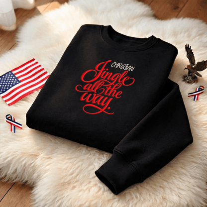 Black Jingle All the Way sweatshirt on a fur rug with a small flag and eagle