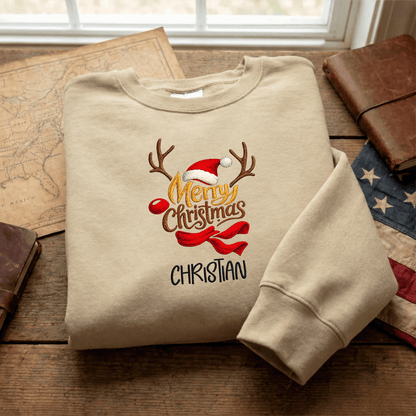Sand Merry Christmas reindeer antlers name sweatshirt folded on a map