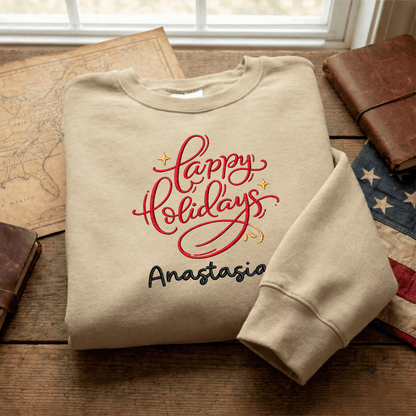 Sand red Happy Holidays name sweatshirt folded on a map with an American flag