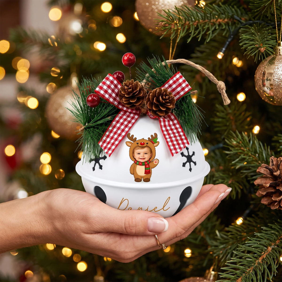 Hand holding a custom baby reindeer photo jingle bell ornament
