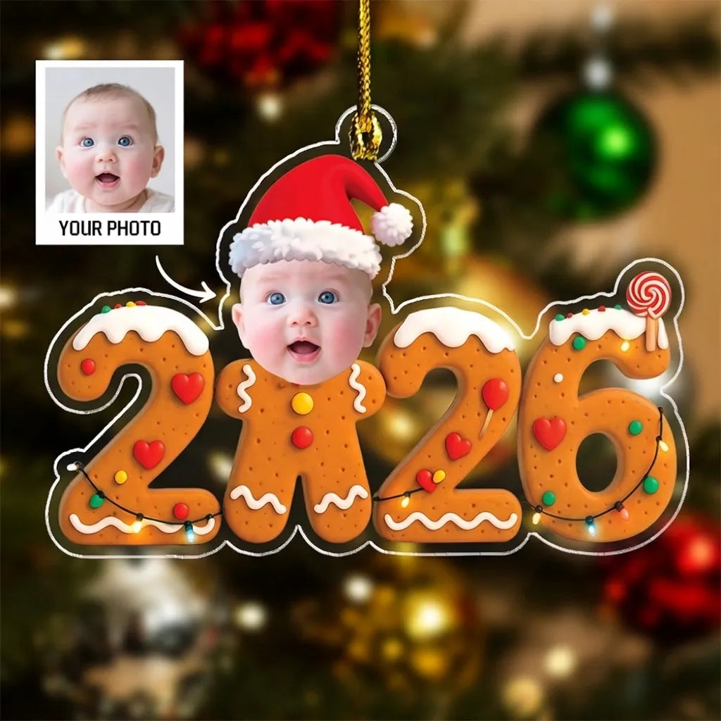Gingerbread 2026 acrylic ornament with a baby photo face in a Santa hat and a sample of the photo to upload