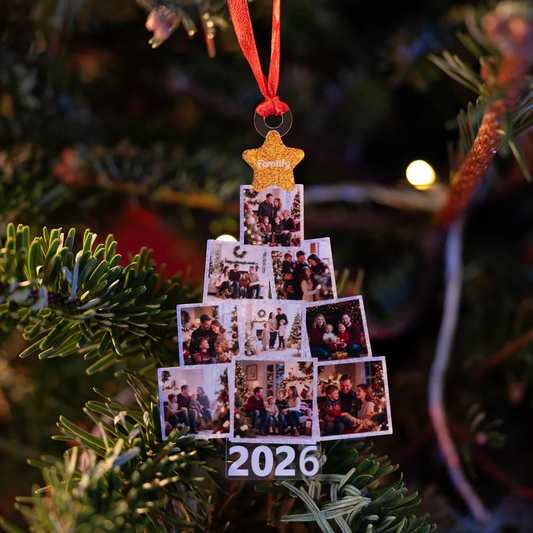 Family photo tree ornament with gold star topper and 2026 hanging by a red ribbon on a Christmas tree