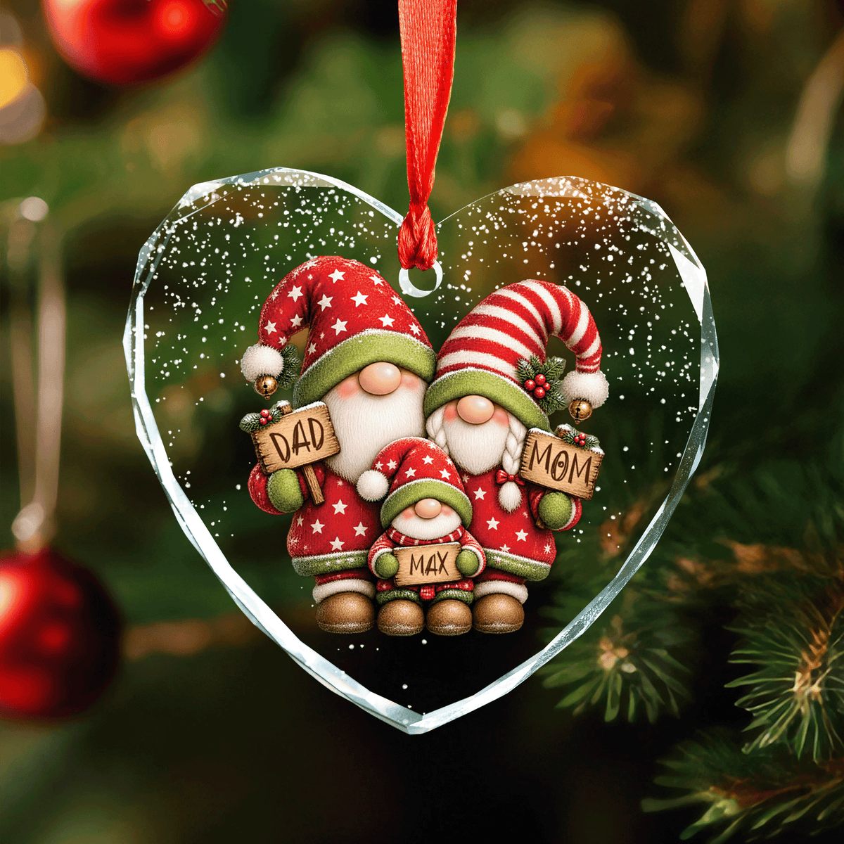 Heart shaped clear glass ornament with a gnome family of mom, dad and one kid holding name signs