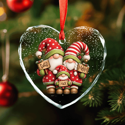 Heart shaped clear glass ornament with a gnome family of mom, dad and one kid holding name signs