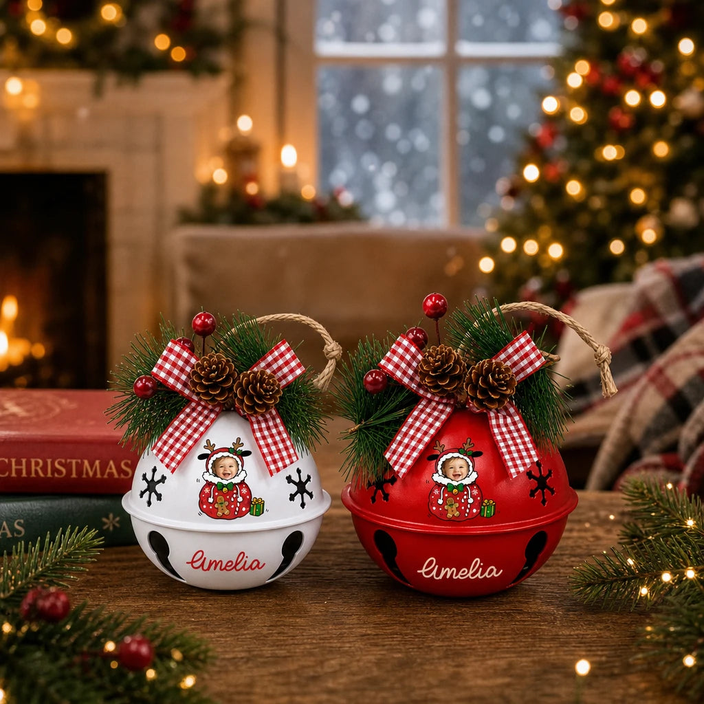 Two personalized baby photo jingle bell ornaments by the fireplace, bell color options