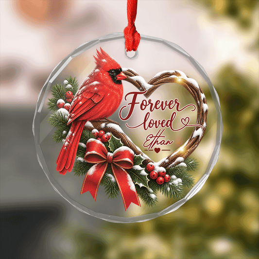 Round clear glass memorial ornament with a cardinal on a snowy heart branch, Forever Loved and a custom name