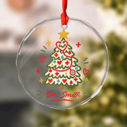 Round clear glass ornament with a stethoscope Christmas tree, hearts and a custom doctor name
