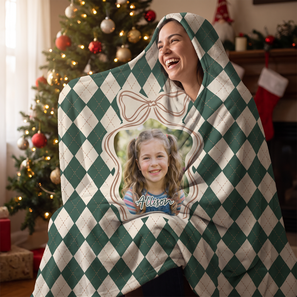 Smiling woman snuggled in the custom photo Argyle Bow Frame hooded blanket with her cat by the Christmas tree