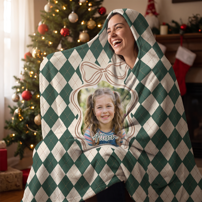 Smiling woman snuggled in the custom photo Argyle Bow Frame hooded blanket with her cat by the Christmas tree