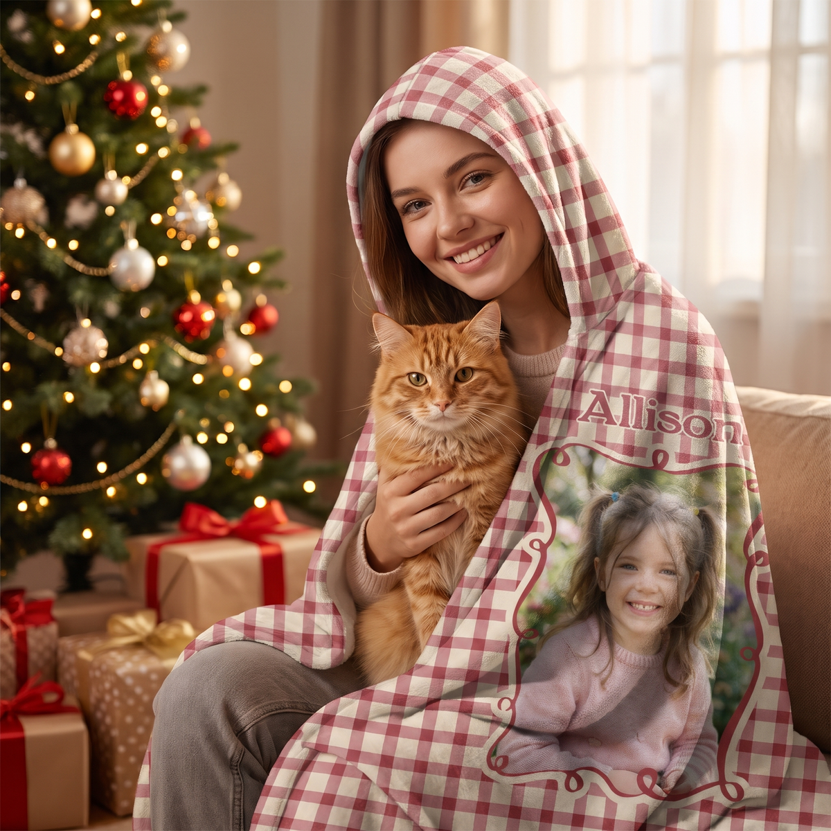 Smiling woman snuggled in the custom photo Red Gingham Frame hooded blanket with her cat by the Christmas tree