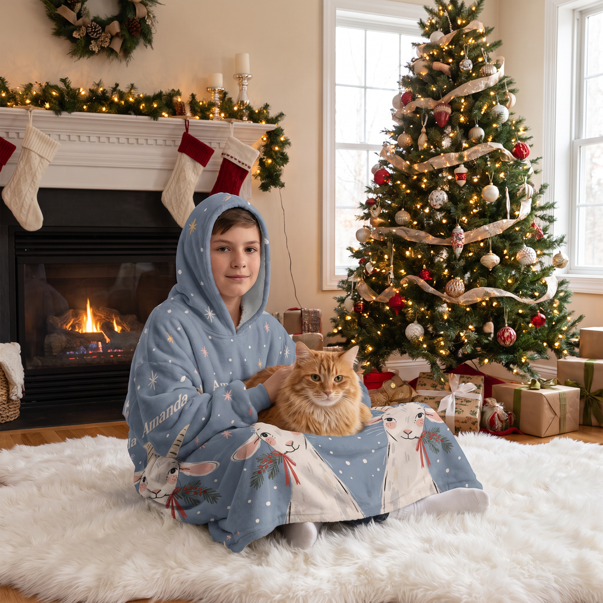 Child wrapped in the Christmas Goats Starry Night hooded blanket holding a cat by the Christmas tree