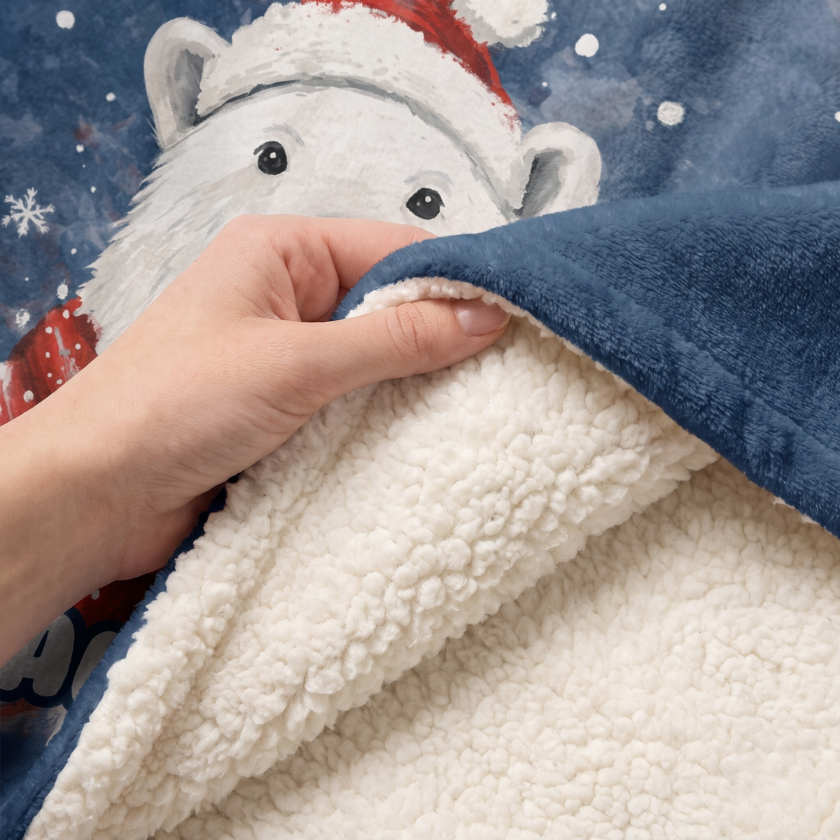 Close-up of the soft sherpa lining inside the Polar Bear Santa Hat Snowfall hooded blanket