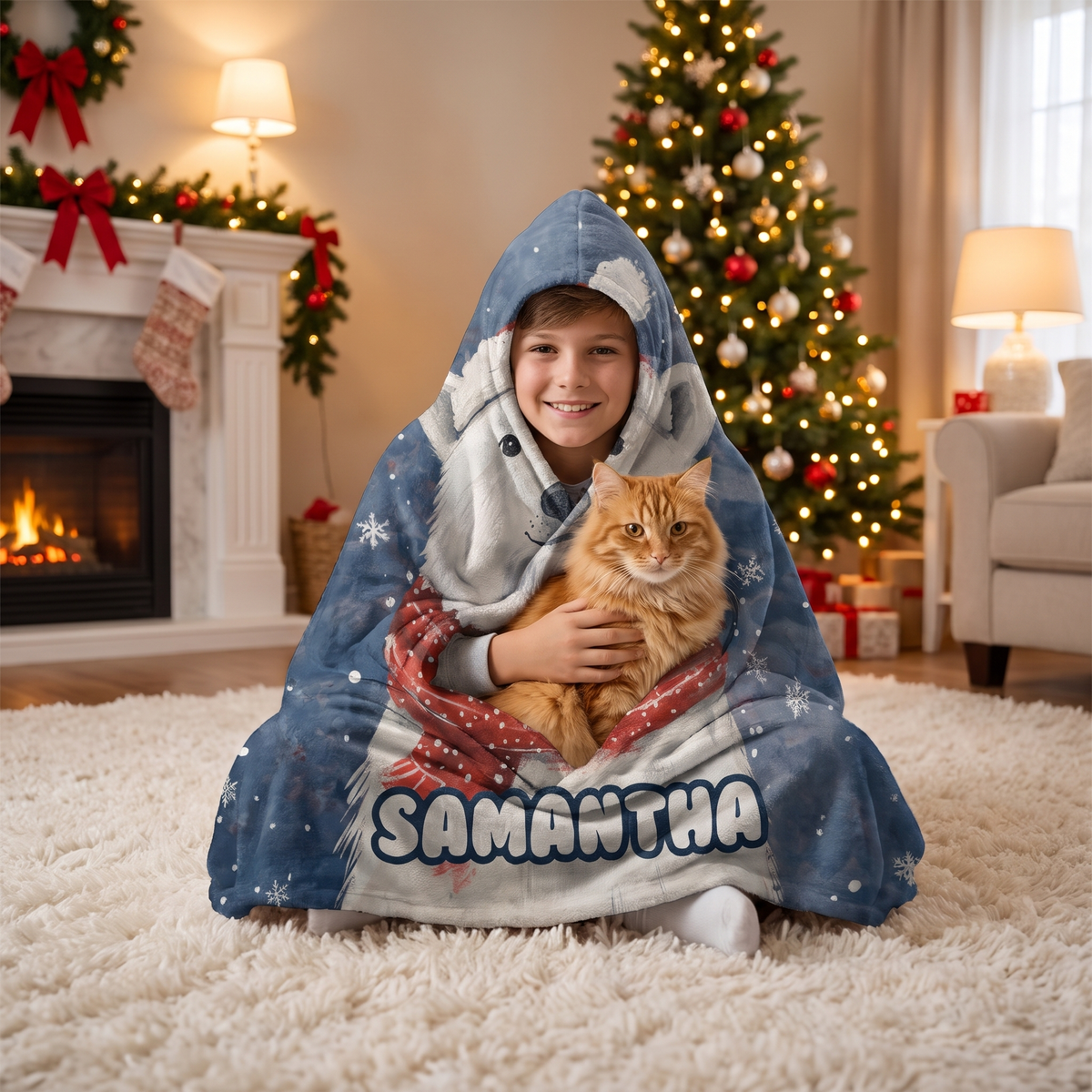 Child wrapped in the Polar Bear Santa Hat Snowfall hooded blanket holding a cat by the Christmas tree