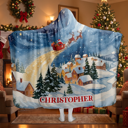 Santa Sleigh Snowy Village hooded blanket worn in a cozy Christmas living room, back view