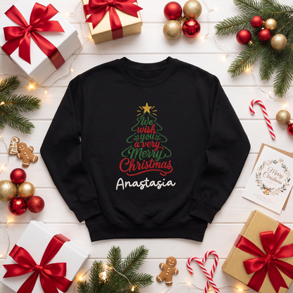 Black sweatshirt embroidered with a Christmas tree formed by We Wish You a Very Merry Christmas script, a gold star and custom name