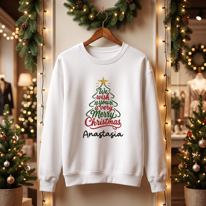 White We Wish You a Merry Christmas name sweatshirt on a hanger by a garland