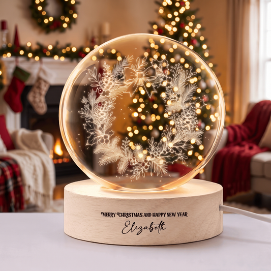 Crystal ball engraved with a pinecone and holly wreath on a wooden LED base reading Merry Christmas and Happy New Year with custom name